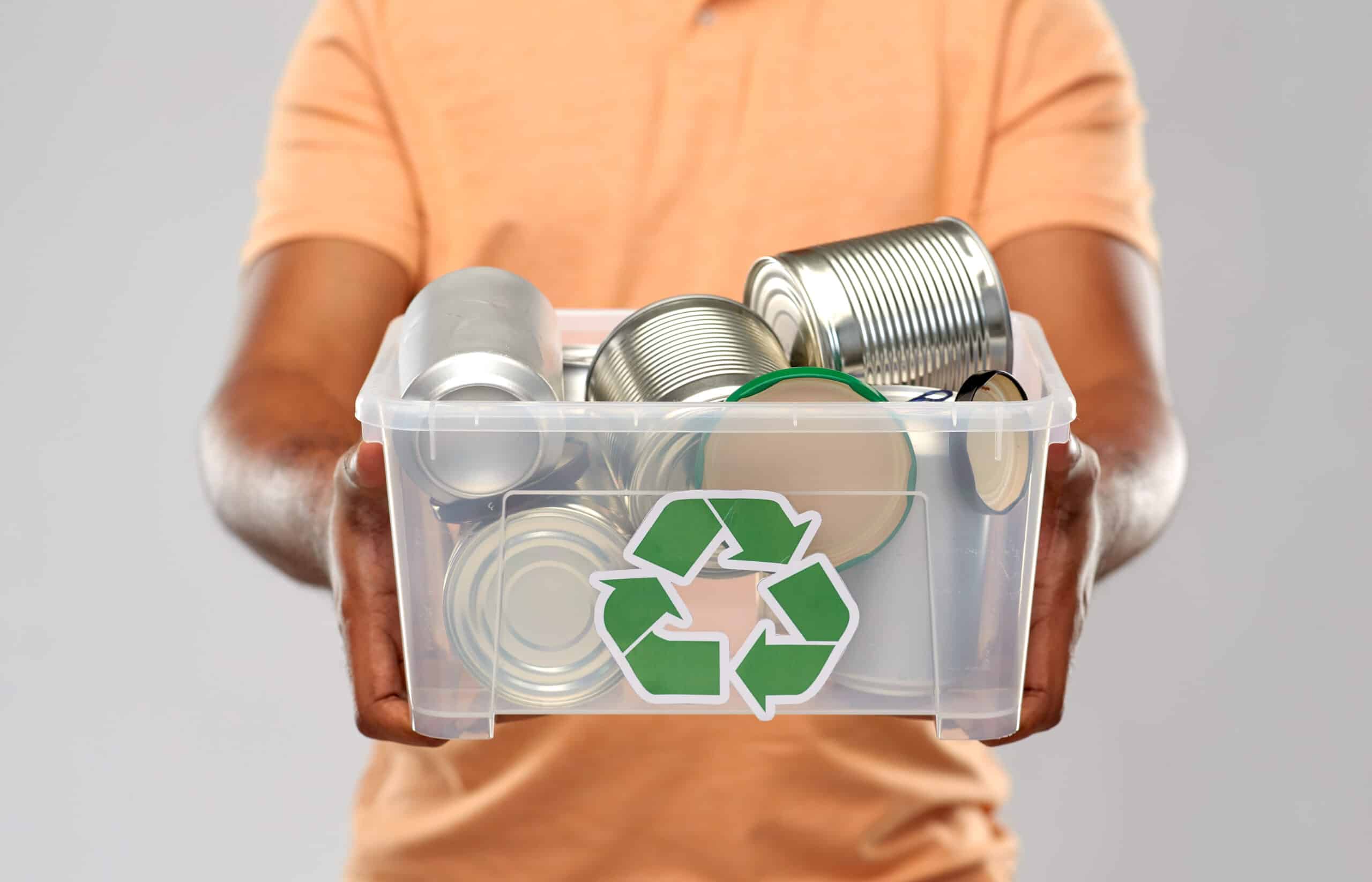 close up of young man sorting metallic waste